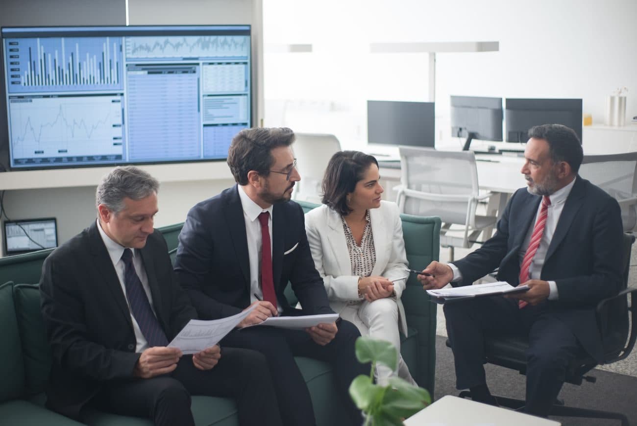 The GeetekFinance team reviewing market positions together