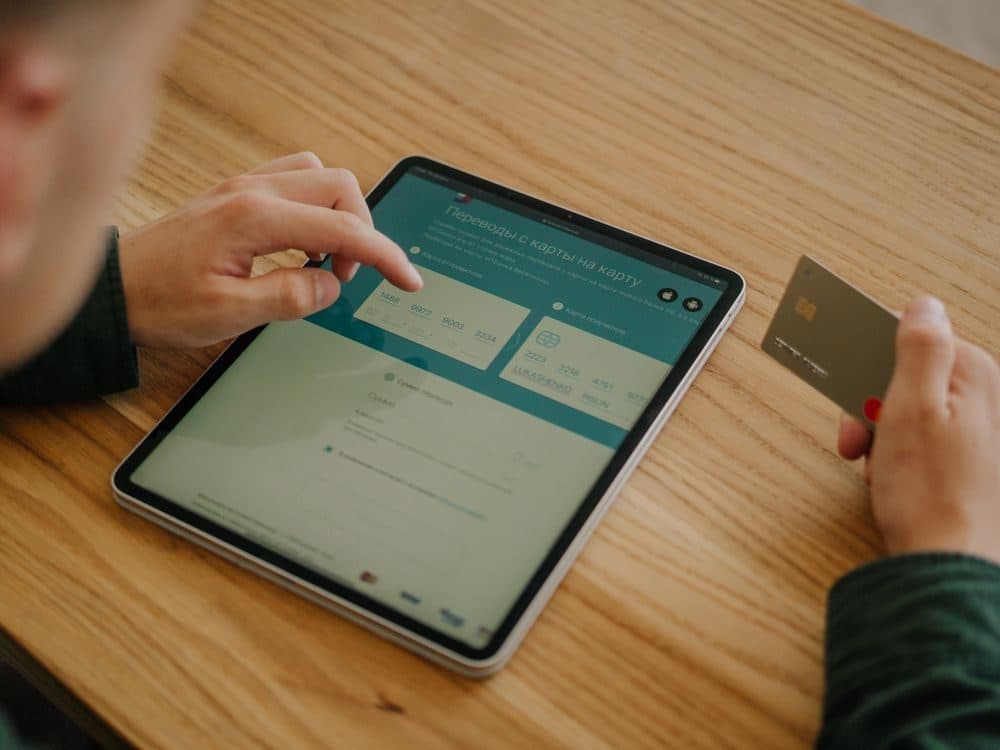 Investor funding an account from a tablet with a bank card