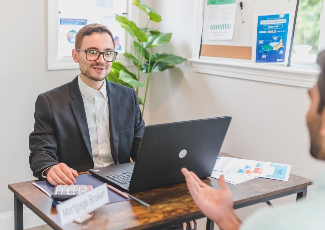 New investor being walked through account setup at a laptop